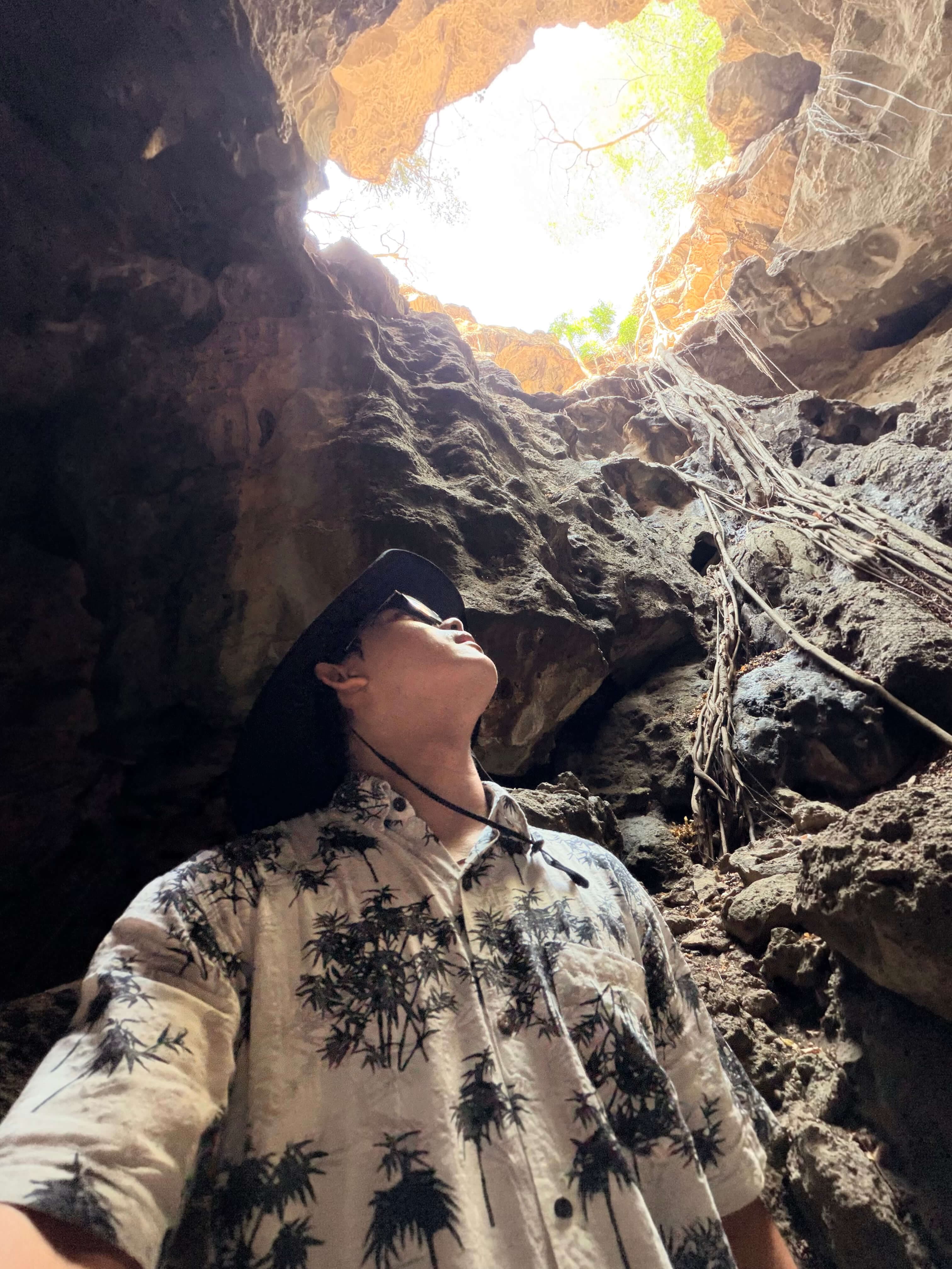 Kyaw Zin Thet in a cave looking up toward the light